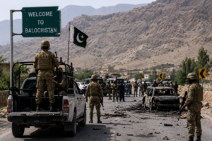 Pakistani security personnel securing a highway during a counterterrorism operation in Balochistan following militant attacks in July 2026.
